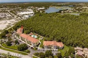 Bird's eye view with a water view and a wooded view