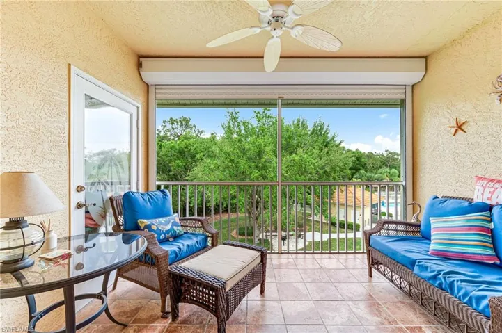 Sunroom with a wealth of natural light and a ceiling fan