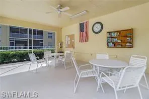View of patio featuring outdoor dining space, ceiling fan, and fence