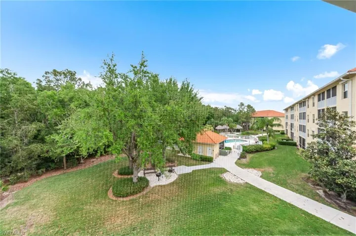 View of property's community with a lawn