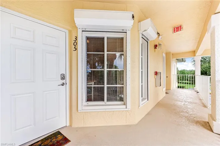 Doorway to property featuring stucco siding
