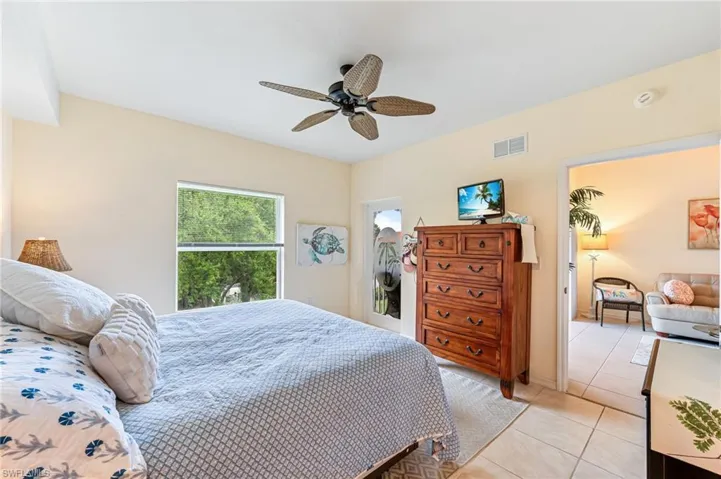 Bedroom featuring visible vents, a ceiling fan, and light tile patterned floors