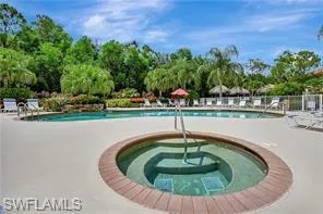 Pool with a patio area and a hot tub