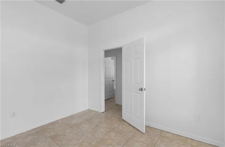 Spare room with light tile patterned floors