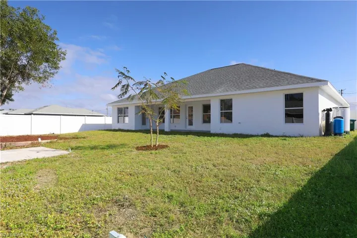 Rear view of house featuring a yard