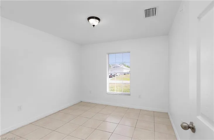 Spare room with light tile patterned floors