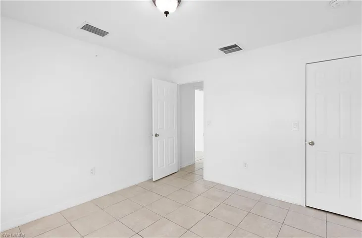 Unfurnished room featuring light tile patterned floors