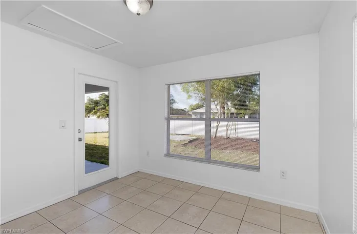 Unfurnished room featuring light tile patterned floors