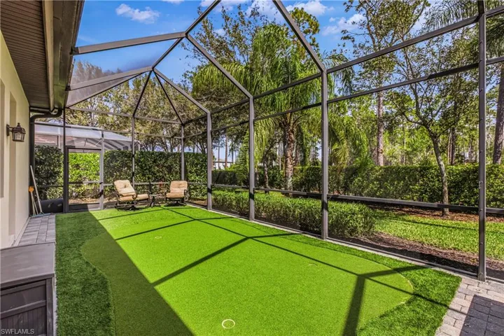Relaxing pool / spa featuring a patio area, screen in lanai and putting green