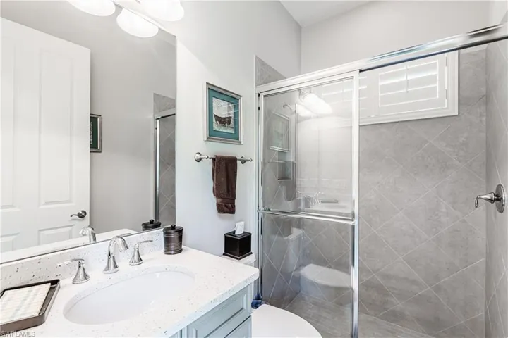 Bathroom with vanity and a shower stall