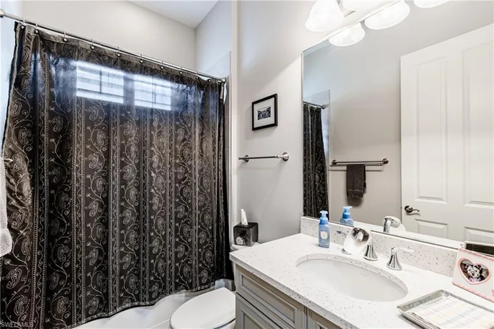 Bathroom with vanity and shower / bathtub combination