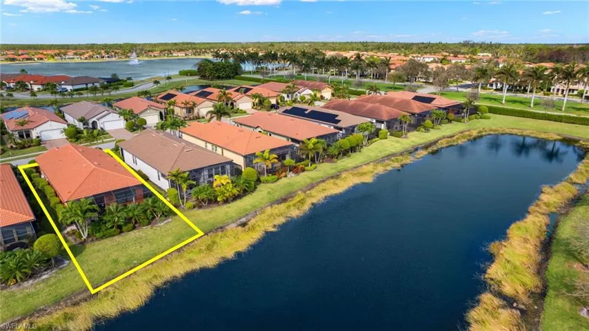 Drone view featuring tranquil water views and upgraded landscaping.