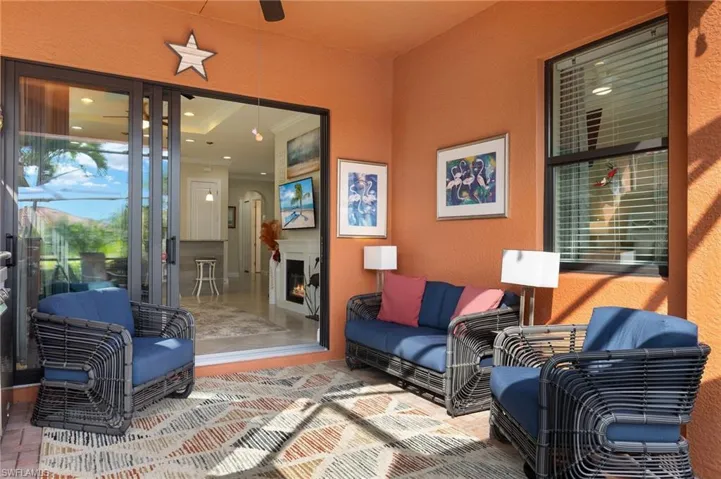 Patio area with plenty of seating, ceiling fan, noseeum screened lanai and beautiful lake views.