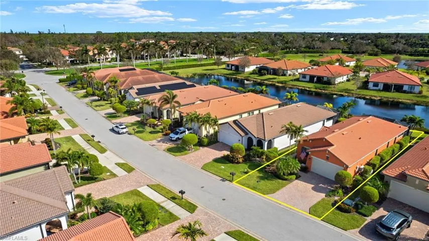 Aerial view featuring tranquil water views and upgraded landscaping.