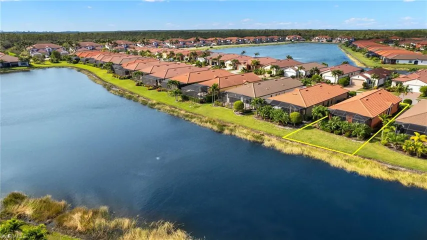Aerial view featuring tranquil water views and upgraded landscaping.