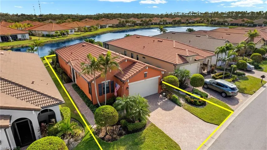 Aerial view featuring tranquil water views and upgraded landscaping.