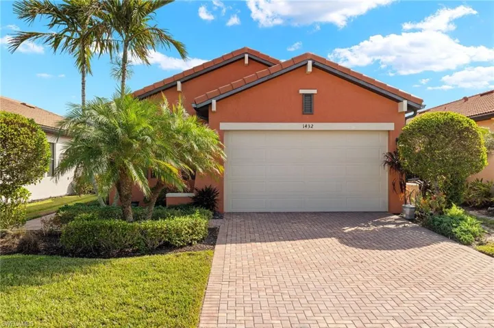 View of front of home featuring a 2 car attached garage and driveway with pavers.