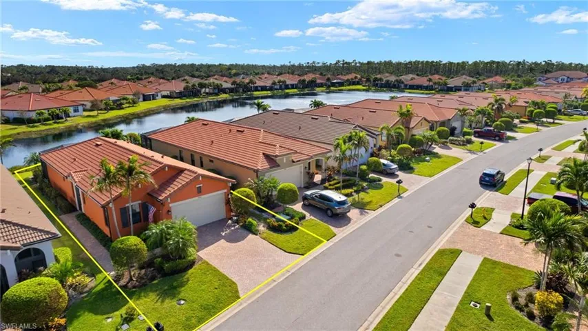 Drone view featuring tranquil water views and upgraded landscaping.