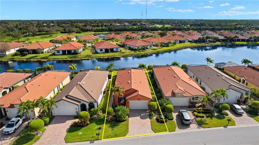 Aerial view featuring tranquil water views and upgraded landscaping.