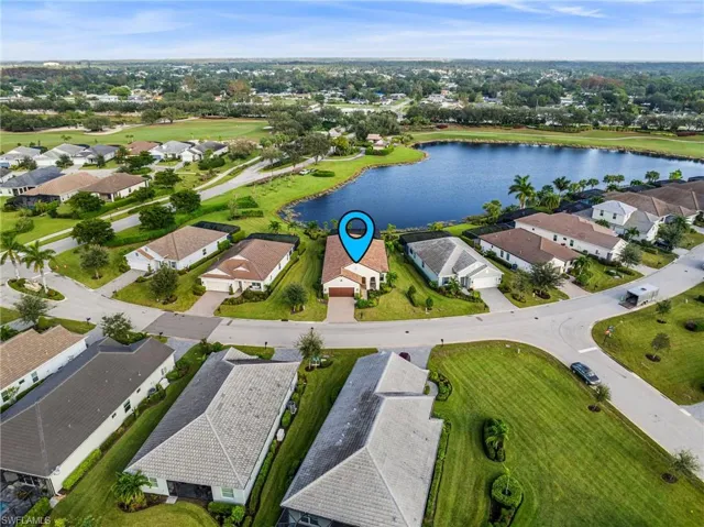 Birds eye view of property with a water view