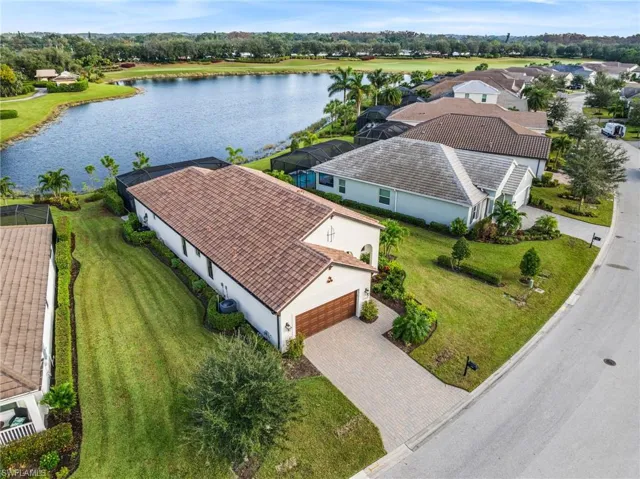 Birds eye view of property with a water view