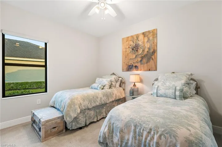 Bedroom featuring ceiling fan and light carpet