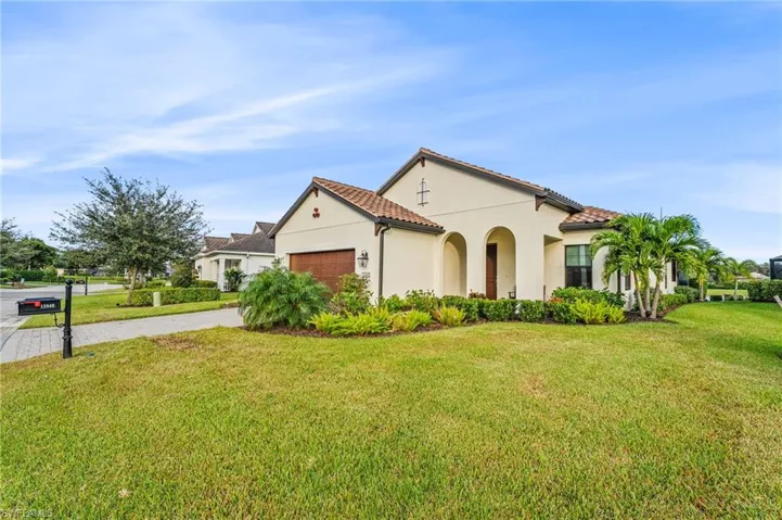 Mediterranean / spanish house with a front yard and a garage