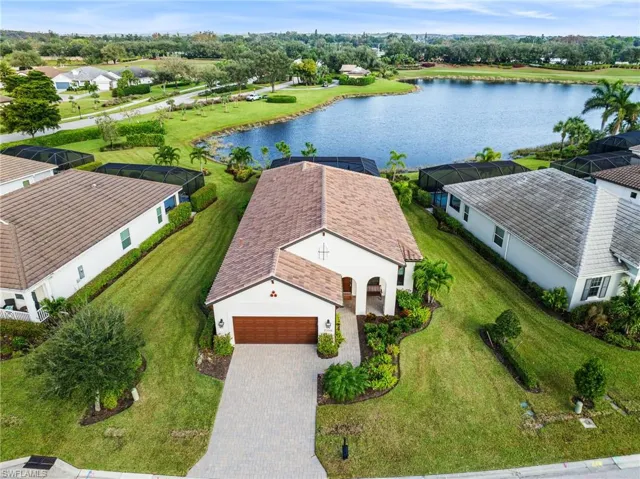 Birds eye view of property with a water view