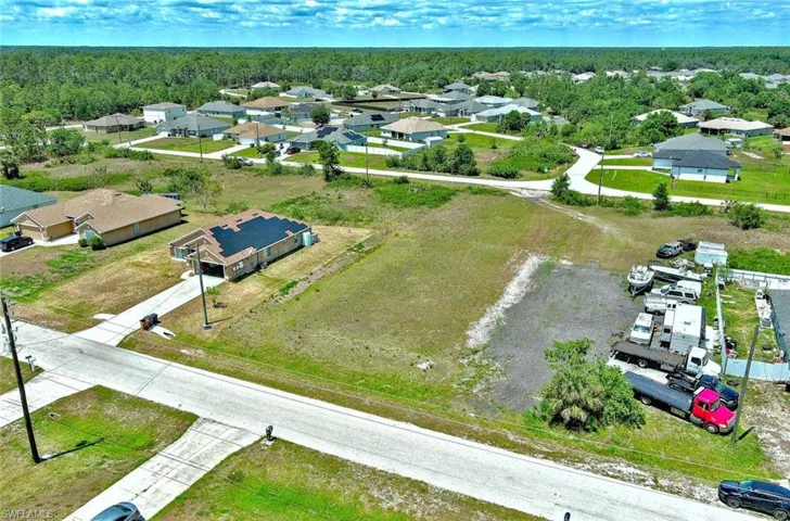Aerial view of residential area featuring a heavily wooded area