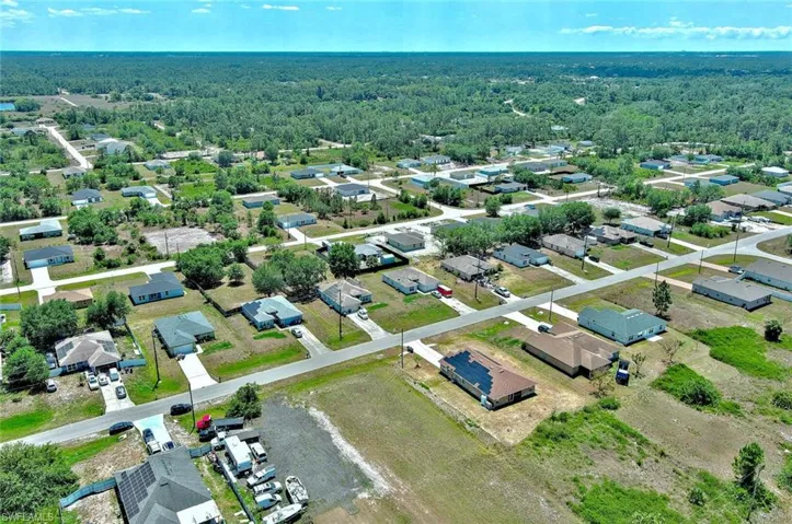 Aerial view of residential area featuring a heavily wooded area