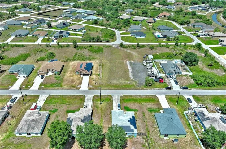 Aerial view of property and surrounding area with nearby suburban area