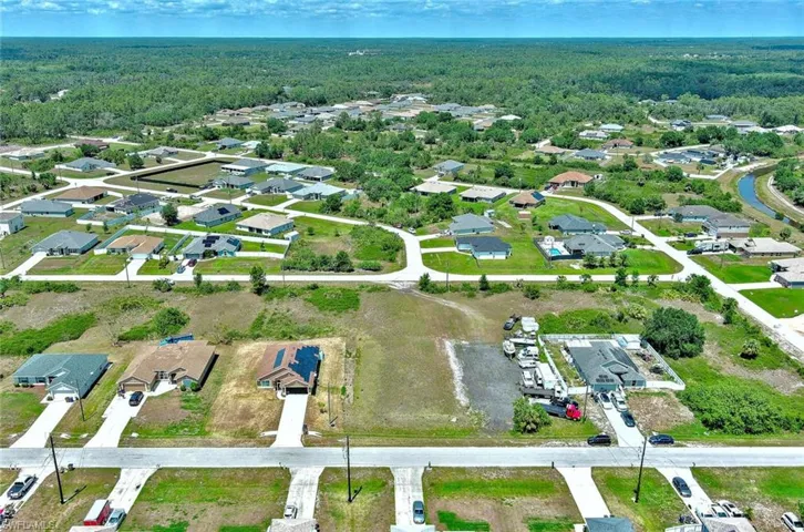 Aerial overview of property's location featuring a heavily wooded area and nearby suburban area
