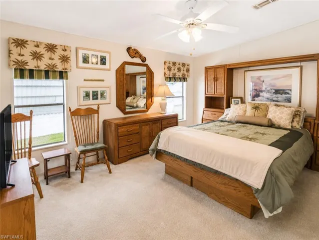Carpeted room with a ceiling fan