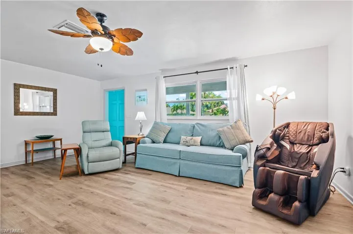 Living room featuring light wood-style flooring and a ceiling fan