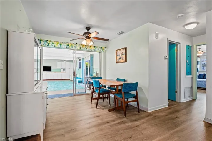 Dining area with a ceiling fan and light wood-style floors