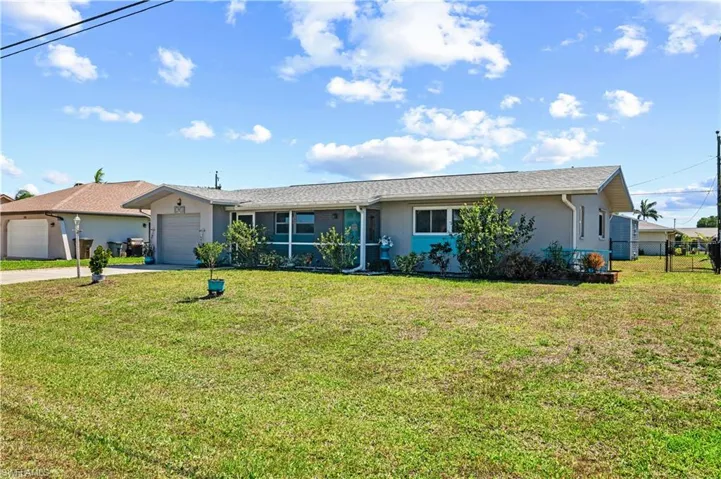 Ranch-style house with stucco siding, concrete driveway, and a garage