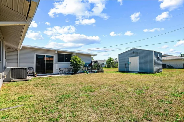 View of yard featuring a shed and a patio area