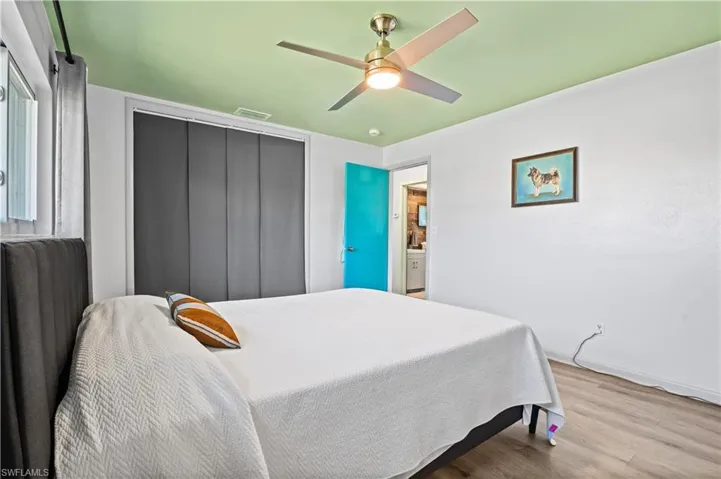 Bedroom featuring wood finished floors, ceiling fan, and a closet