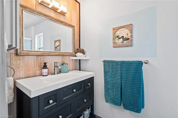 Bathroom with vanity and wooden walls
