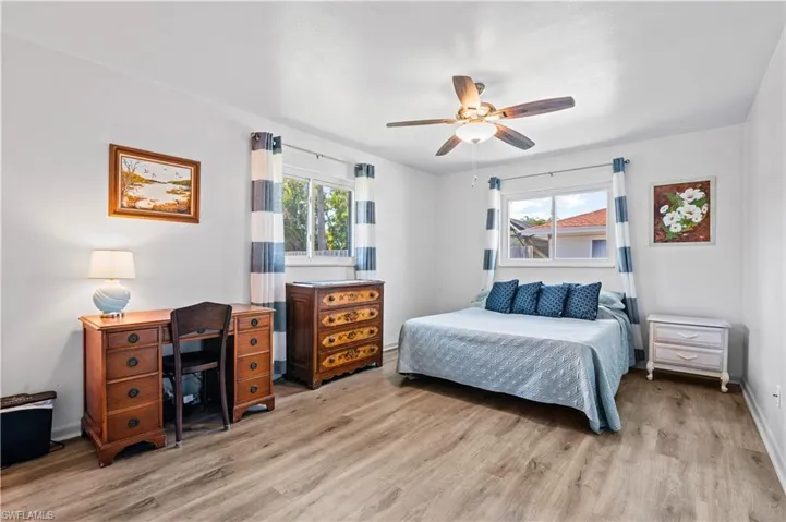 Bedroom with light wood-type flooring and a ceiling fan