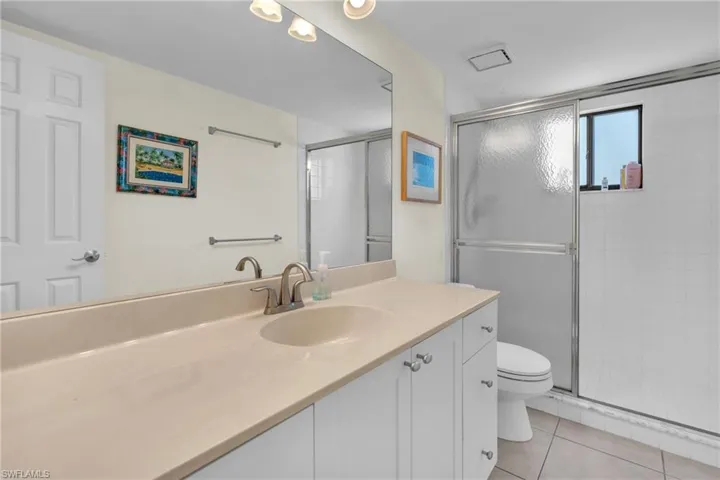 Spa-inspired primary bathroom featuring a spacious dual-sink vanity with ample storage, quartz countertop, and brushed nickel fixtures