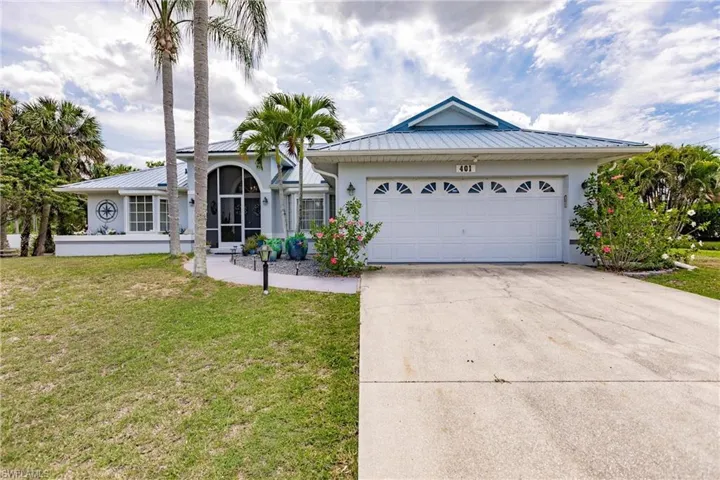 View of front of property with a garage and a front yard