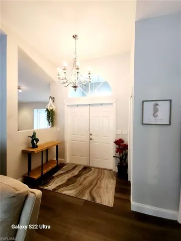 Entryway featuring a chandelier and dark hardwood / wood-style floors