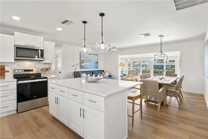 Updated kitchen opens to living & dining area.