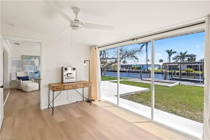 Sliding doors open to an expansive outdoor area, seamlessly blending indoor and outdoor living.