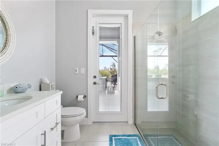Bathroom with a healthy amount of sunlight, vanity, and toilet