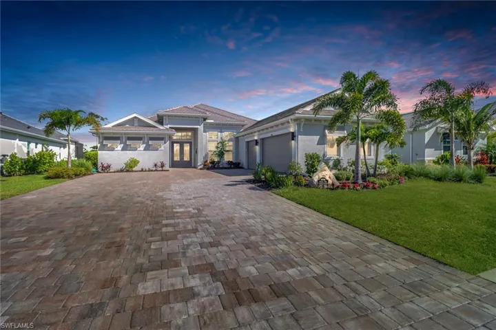 View of front facade with a yard and a garage