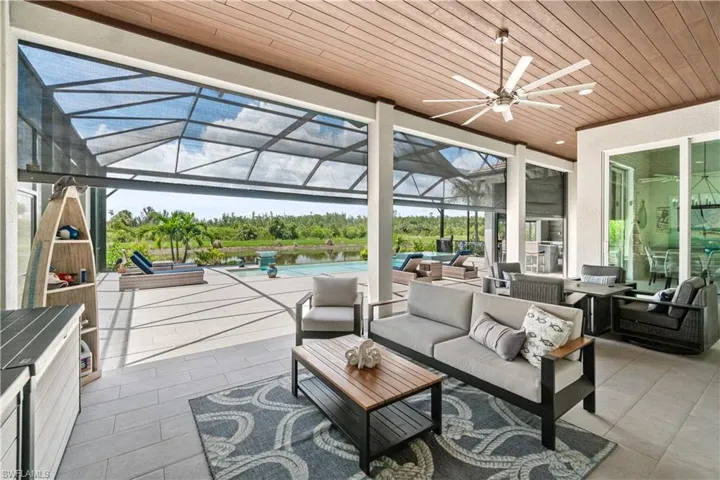 Sunroom / solarium with ceiling fan and wood ceiling