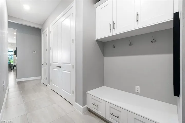 Mudroom with light tile patterned floors