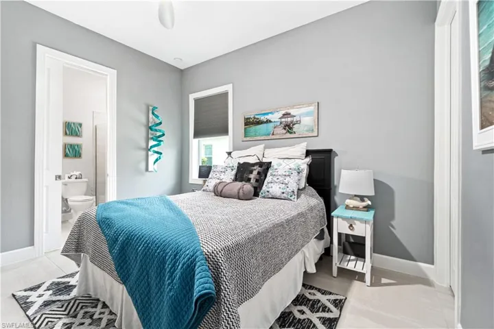Bedroom featuring ensuite bath and light tile patterned floors
